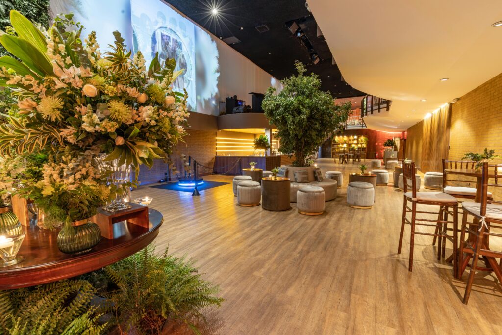 Warm, inviting banquet hall with lush greenery and stylish seating for events.
